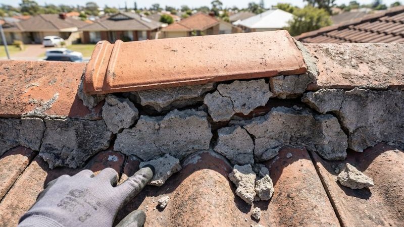Close-up of cracked ridge capping mortar on a Perth rooftop showing signs of thermal damage and water entry