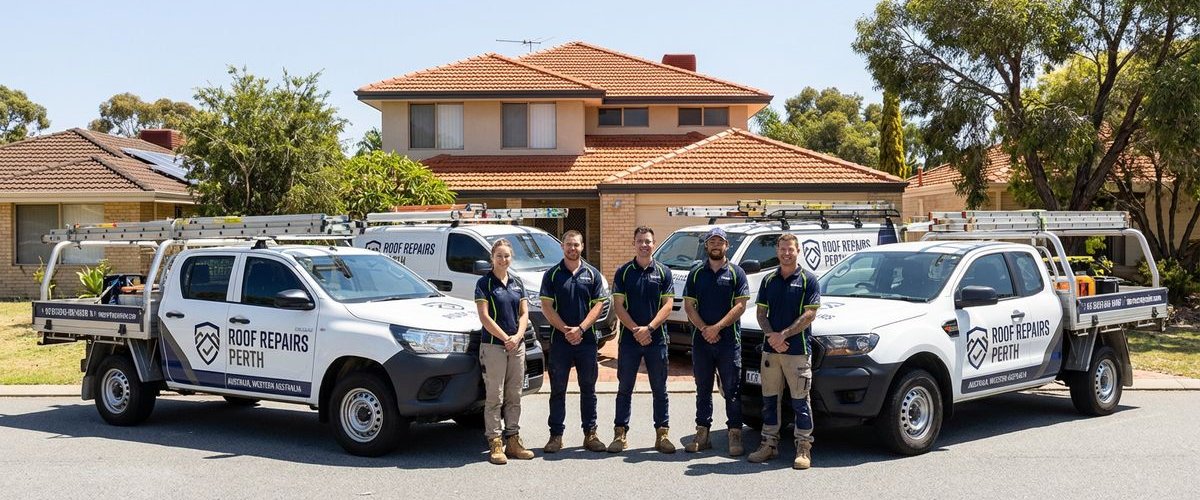 The full Roof Repairs Perth team with work vehicles